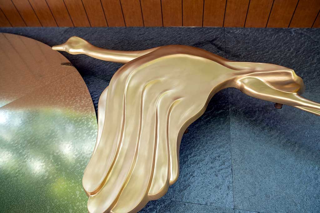 After — wing detail showing smooth gold surface