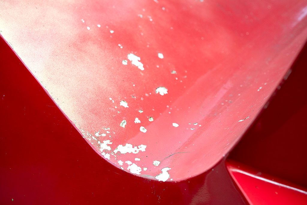 Before — sun-bleached surface showing severe fading