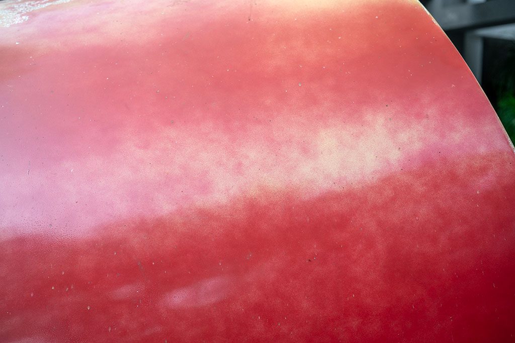 Before — widespread fading and paint peel across panel