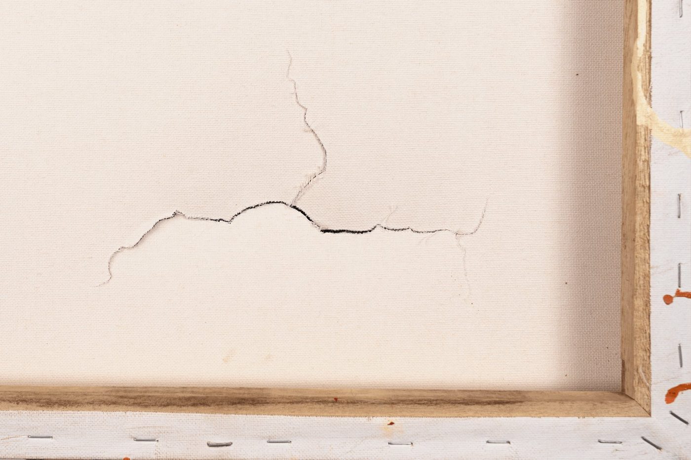 Before restoration — tear visible from reverse